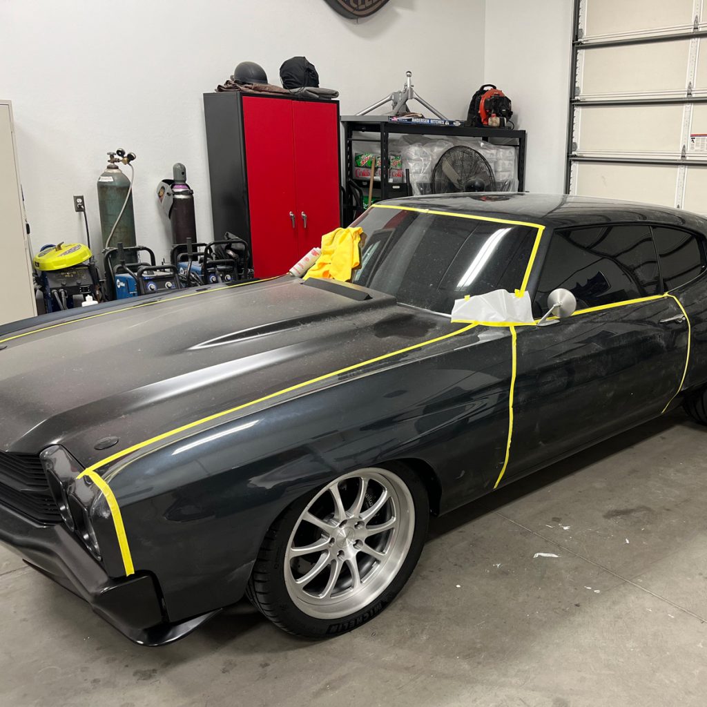 A black dodge challenger in a garage