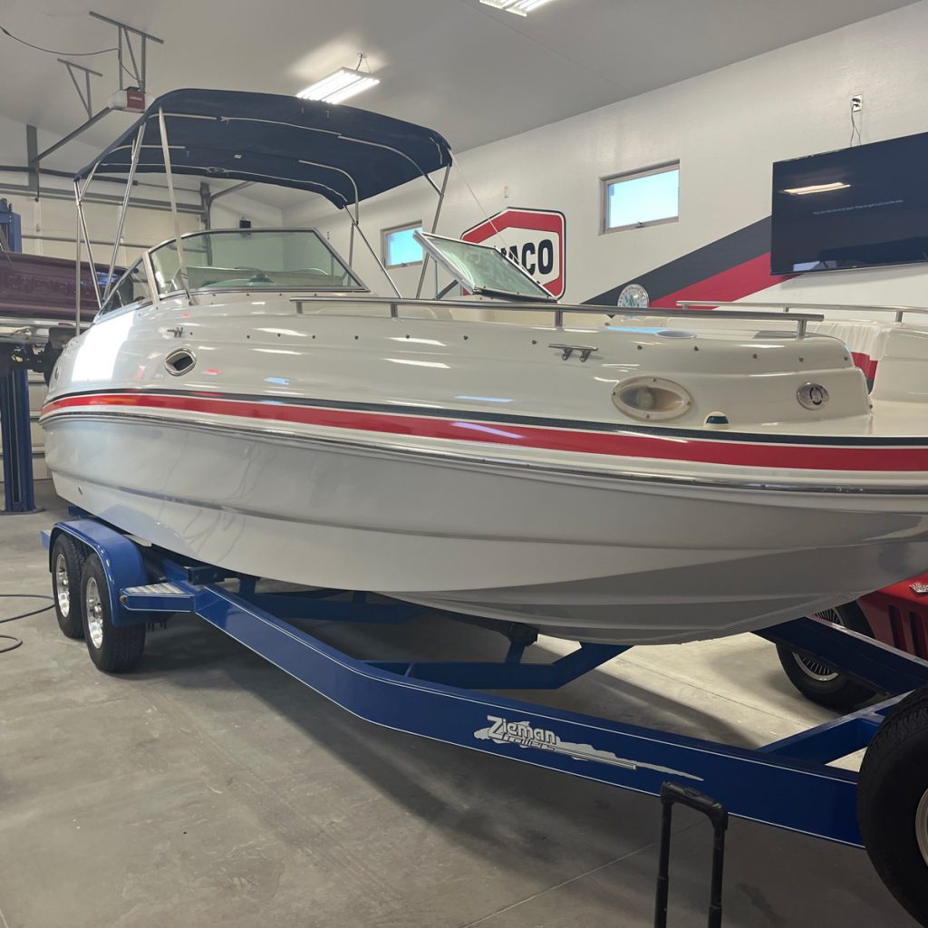 A white speedboat in a garage